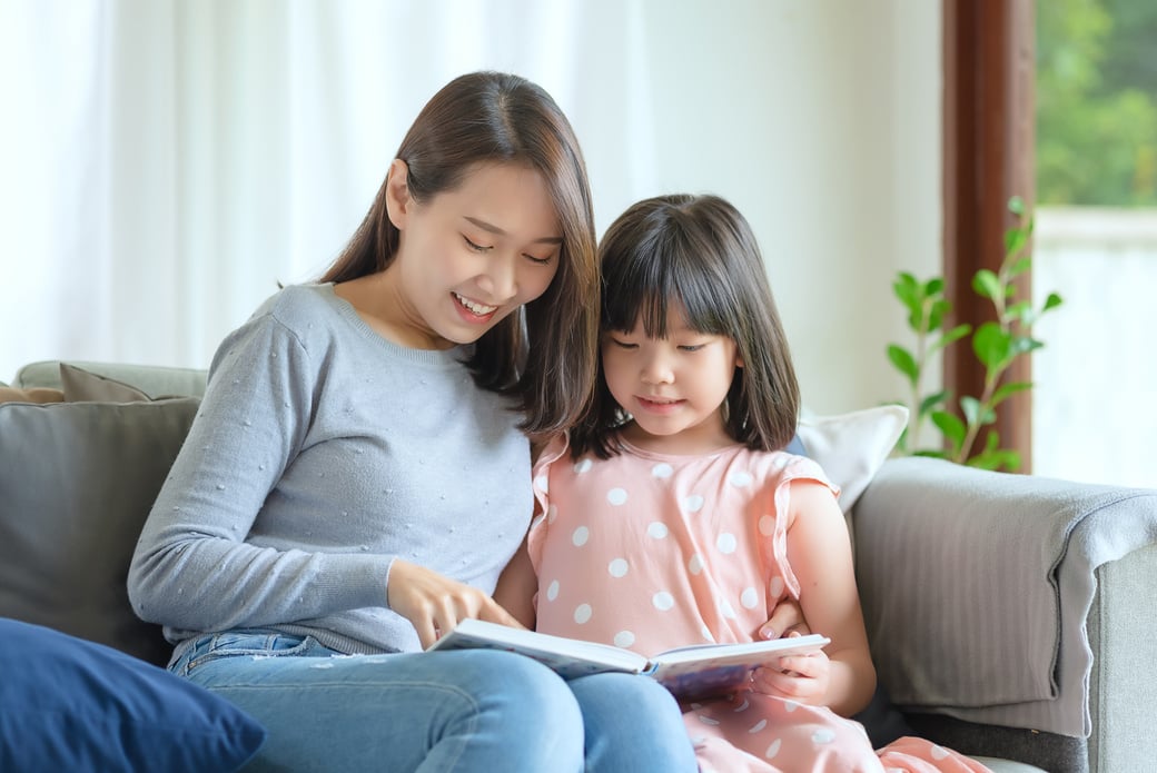 Asian mother teaching her cute daughter to studying at home